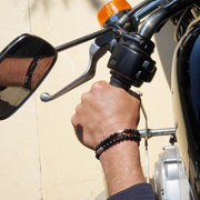 Male Model wearing the Liam Men Beaded Bracelet made with Falcon Eye and Sterling Silver Element and the Maxim Men Beaded Bracelet made with Black Onyx and Sterling Silver Element.